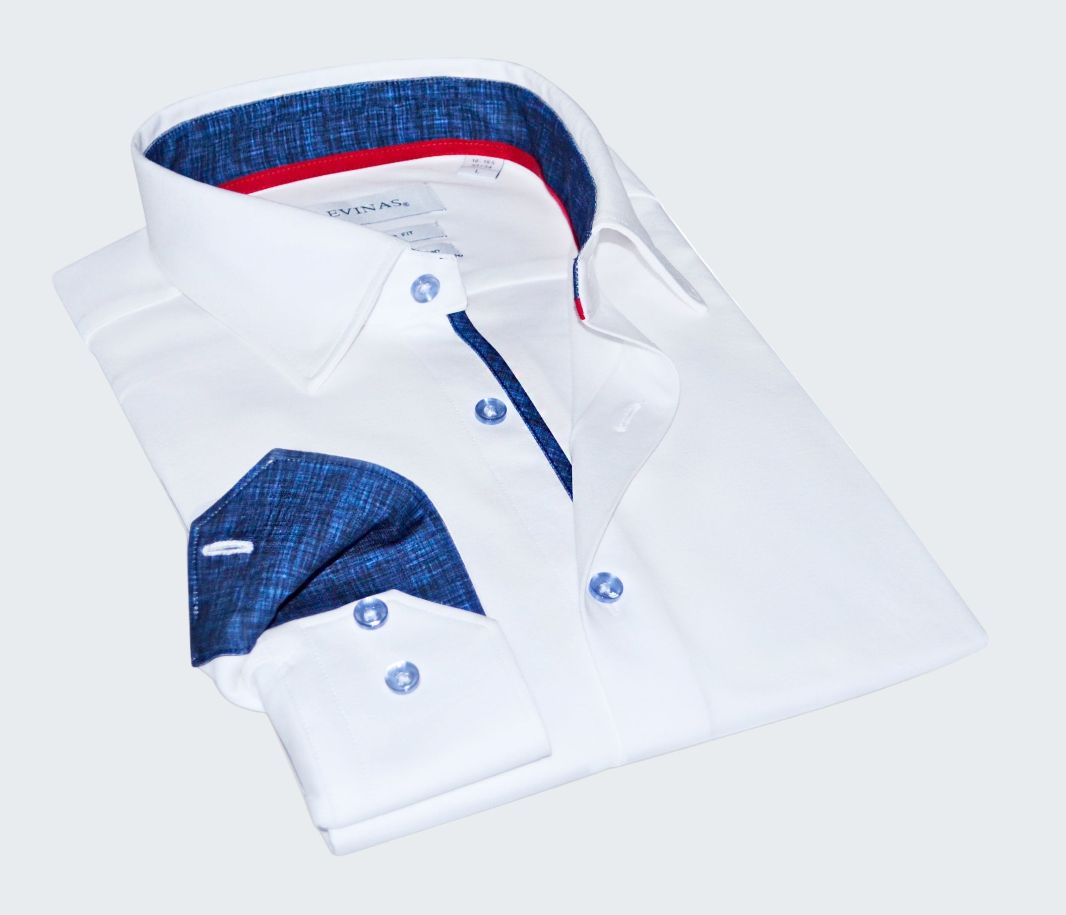 Folded white shirt with blue and red interior details on a white background