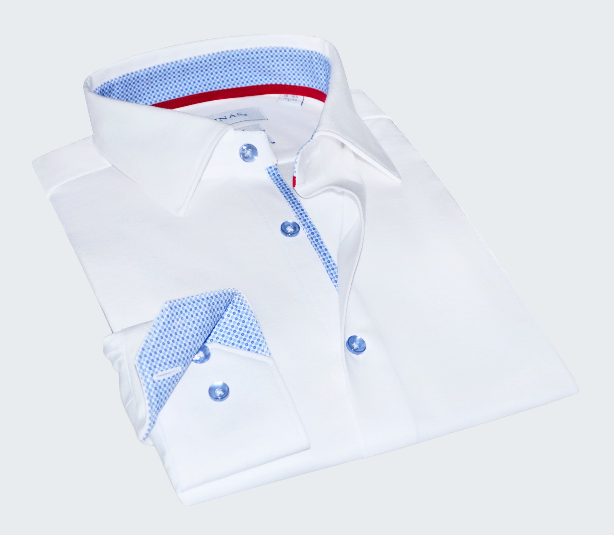 Folded white shirt with blue and red interior details on a white background
