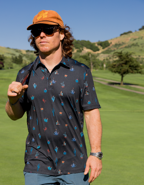 Man wearing a patterned shirt and sunglasses on a golf course