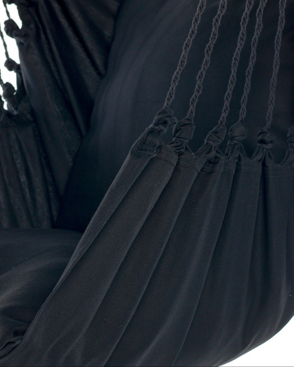 Close-up of a black fabric with tassels and chain details