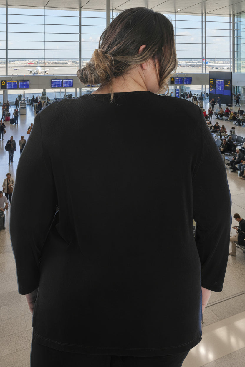 Person wearing a black sweater on a white background