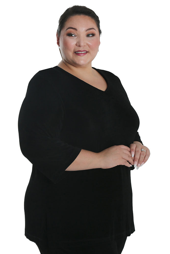Woman wearing a black dress against a white background