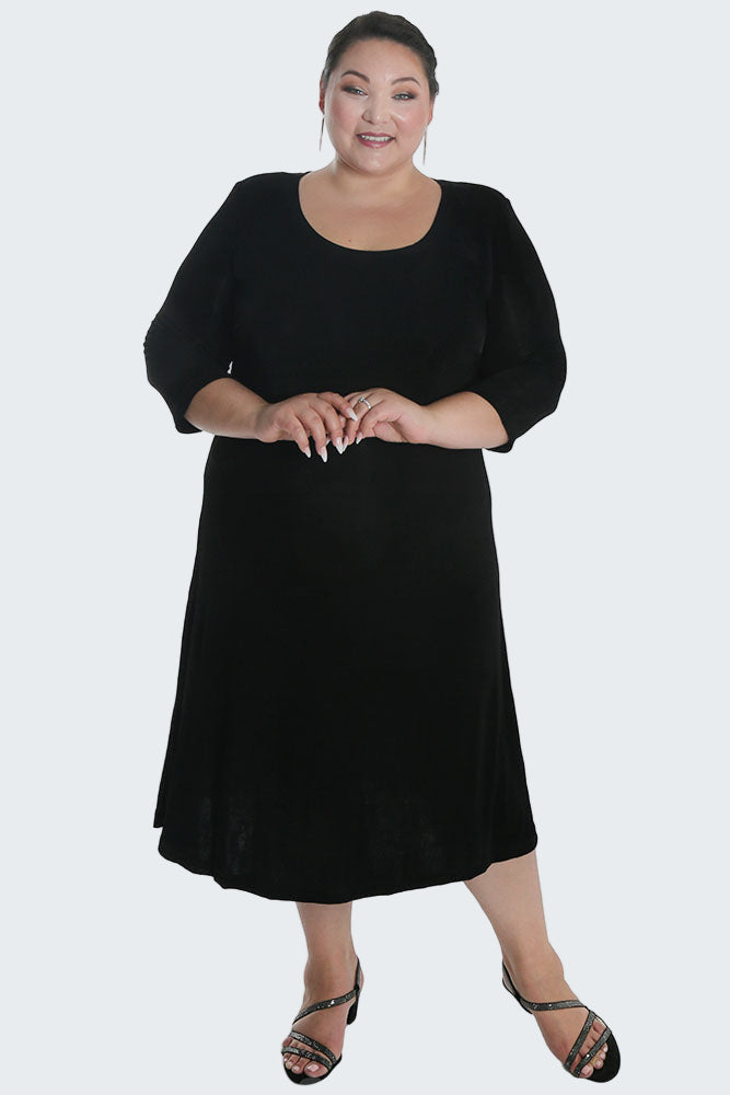 Woman wearing a black dress on a white background