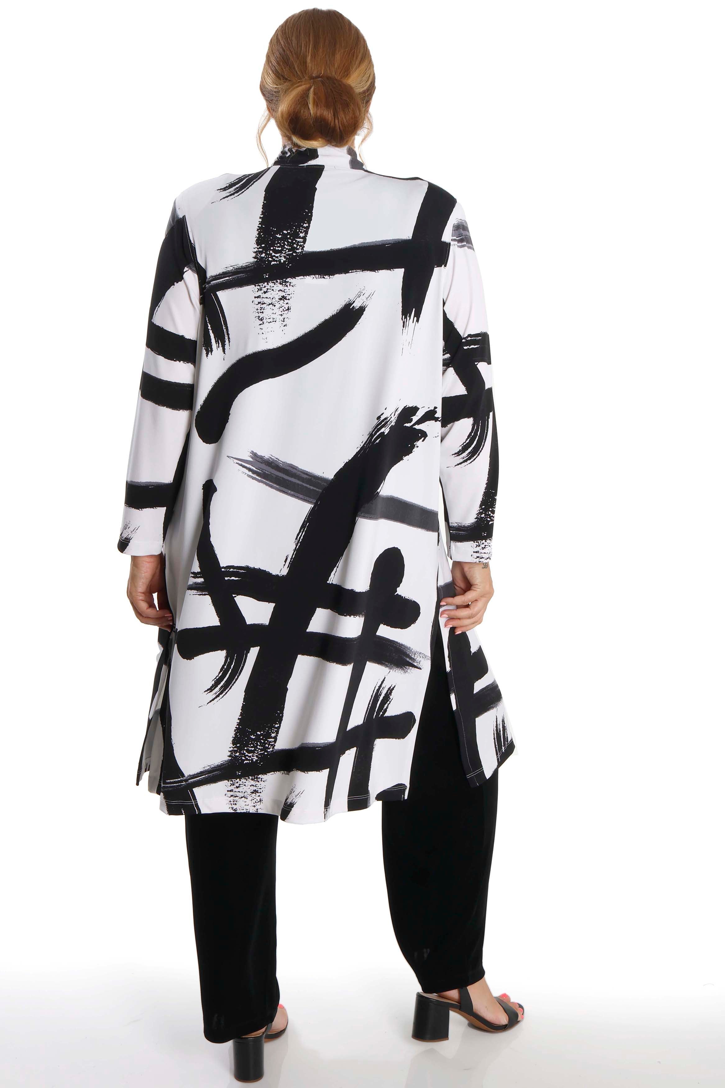 Person wearing a black and white abstract patterned outfit on a white background