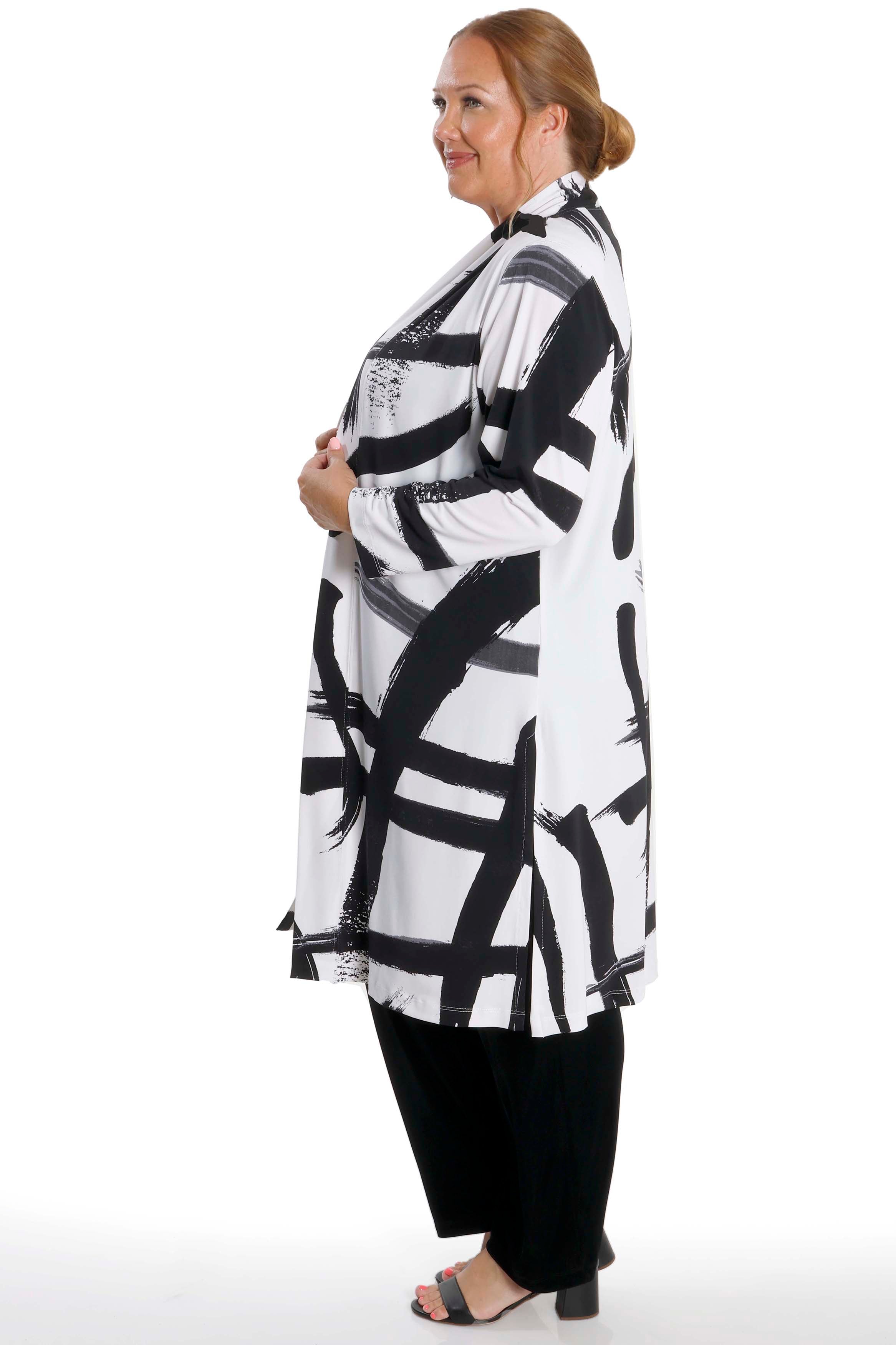 Woman wearing a black and white patterned kimono-style garment on a white background