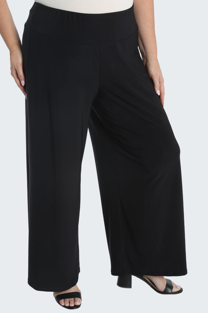 Black wide-leg pants worn by a person on a white background