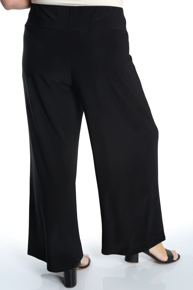 Black wide-leg pants worn by a person on a white background