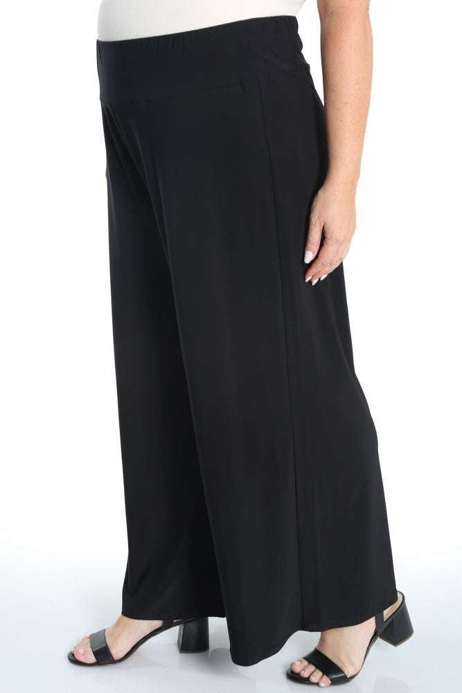 Black wide-leg pants worn by a person on a white background