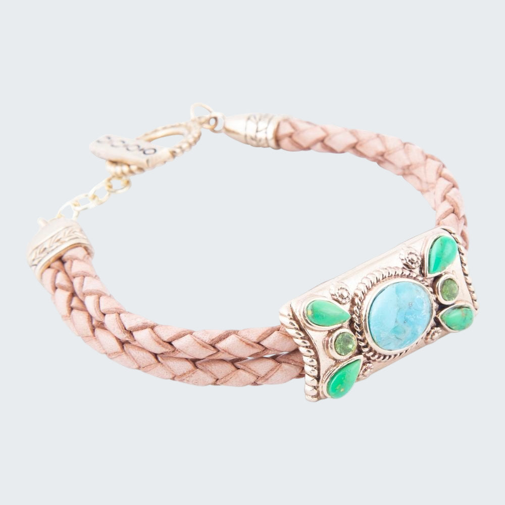 Bracelet with braided design and green gemstone accents on a white background