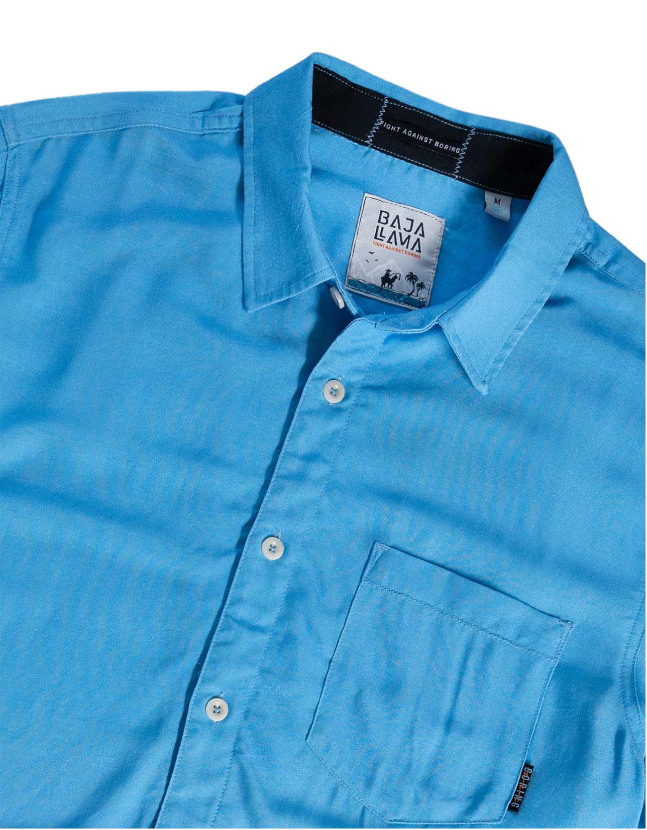 Blue shirt with a visible brand tag on a white background