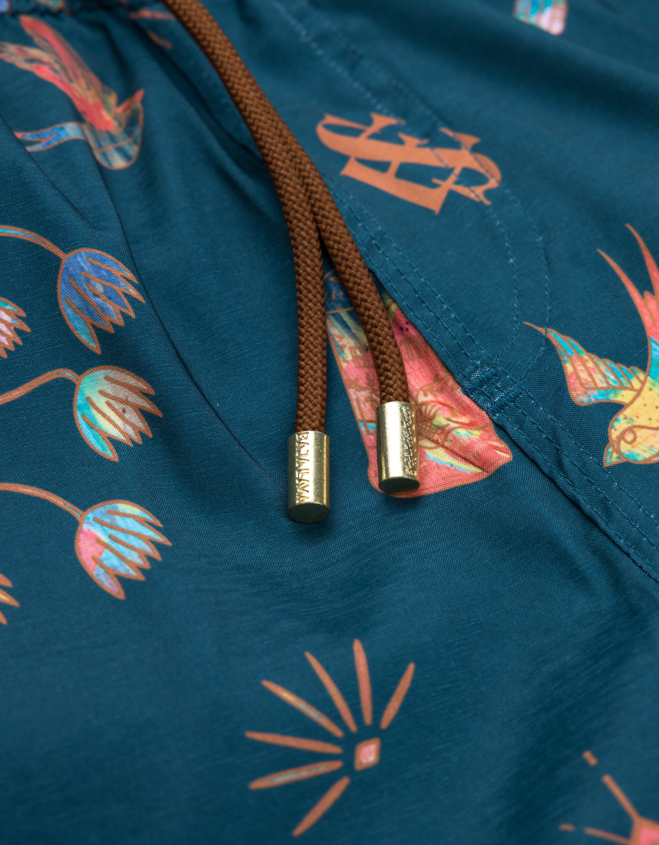 Close-up of a drawstring bag with floral patterns on a blue background
