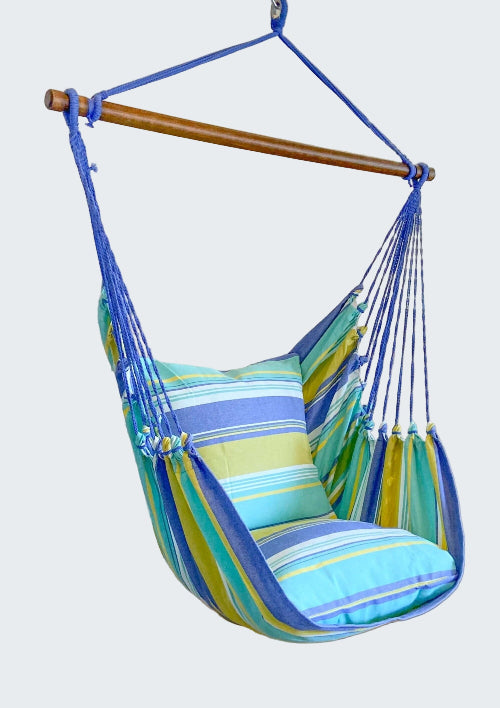 Striped hammock chair with blue, green, and yellow colors in a room setting.