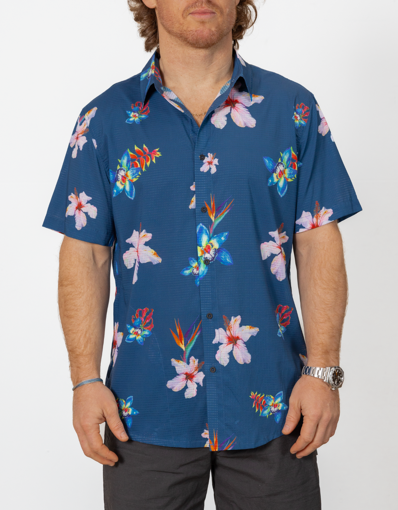 Man wearing a blue floral patterned shirt on a white background