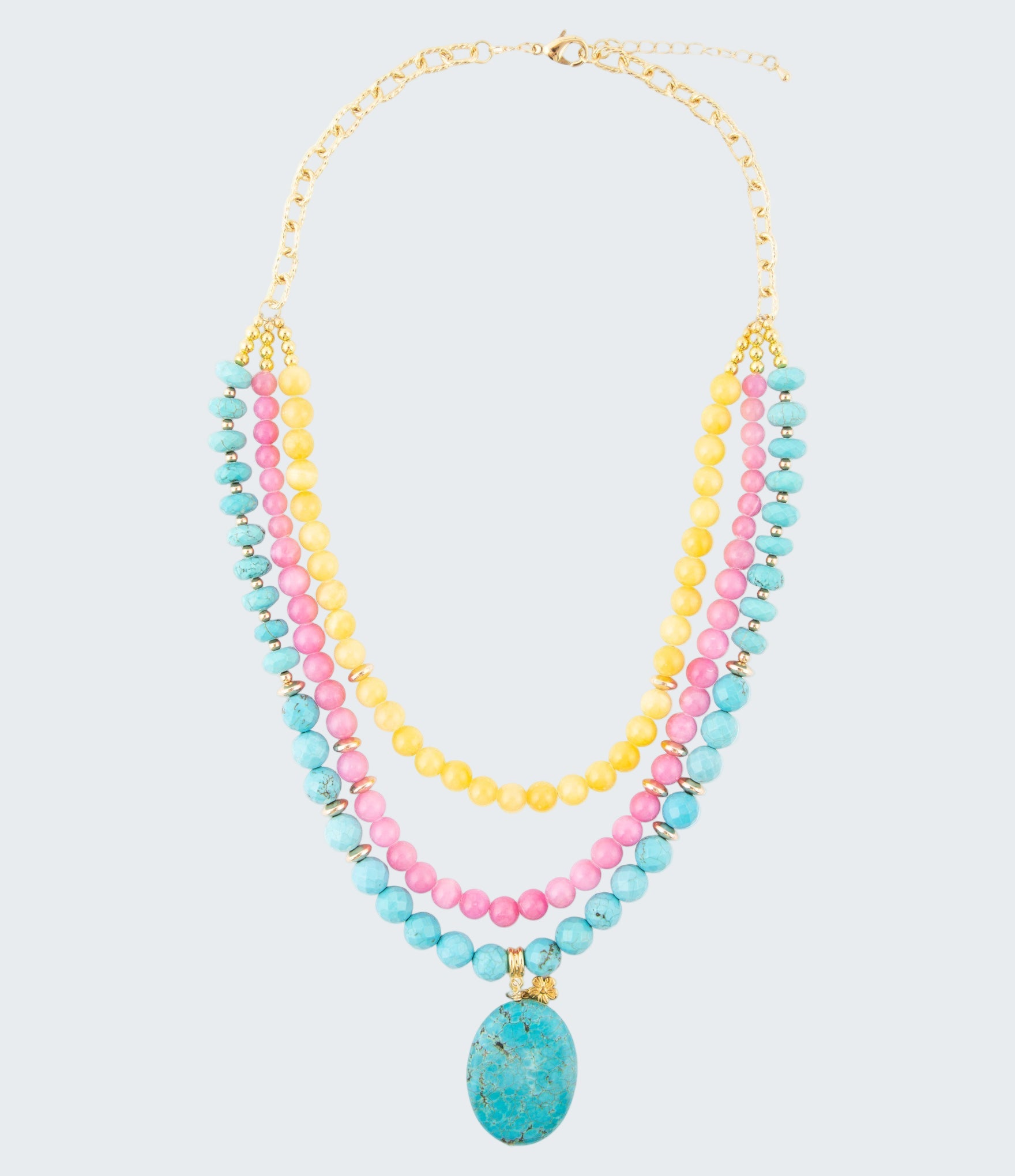 Multistrand beaded necklace with a turquoise pendant on a white background