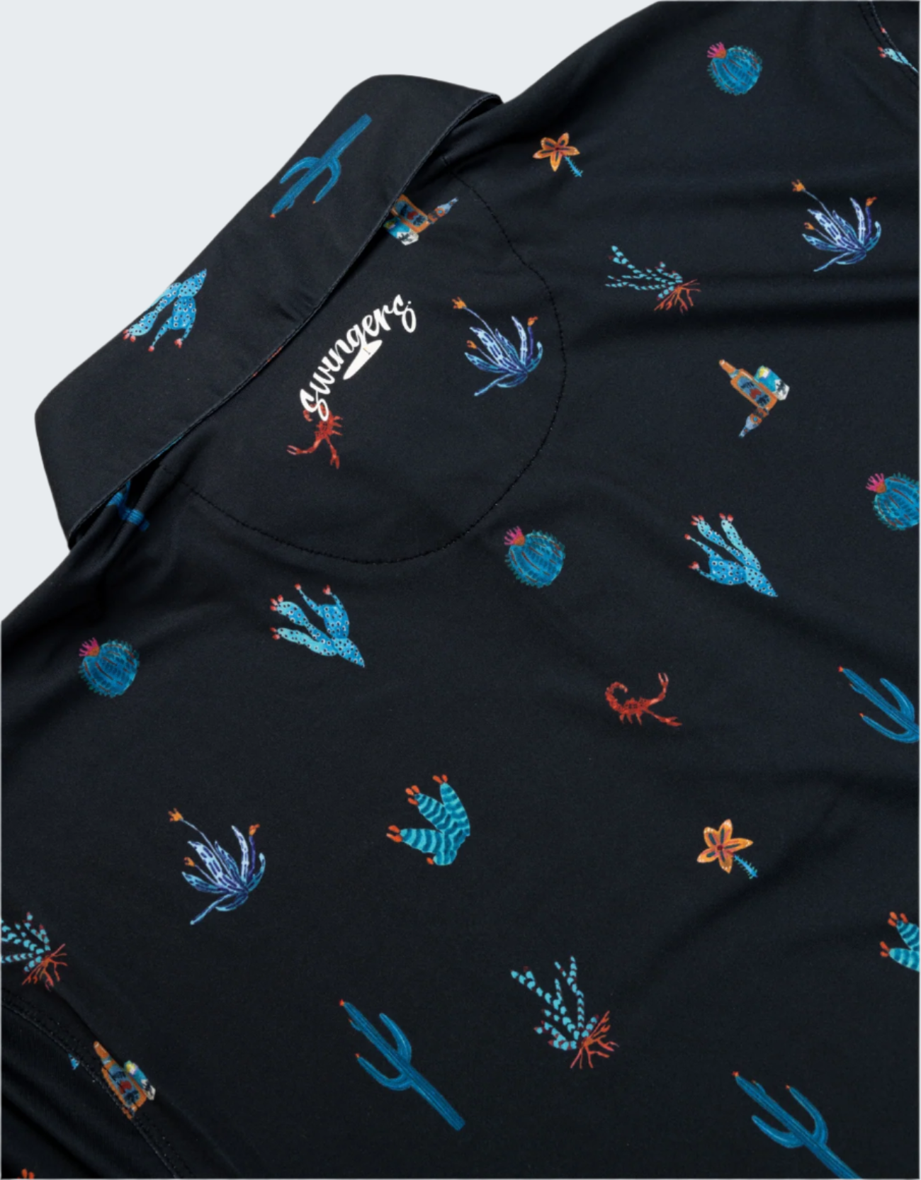 Black shirt with colorful embroidered designs on a white background