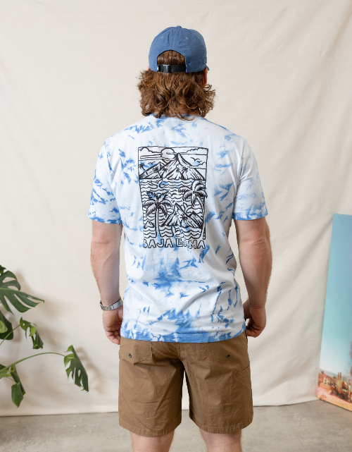Person wearing a tie-dye t-shirt with a graphic design and text, standing against a plain background.