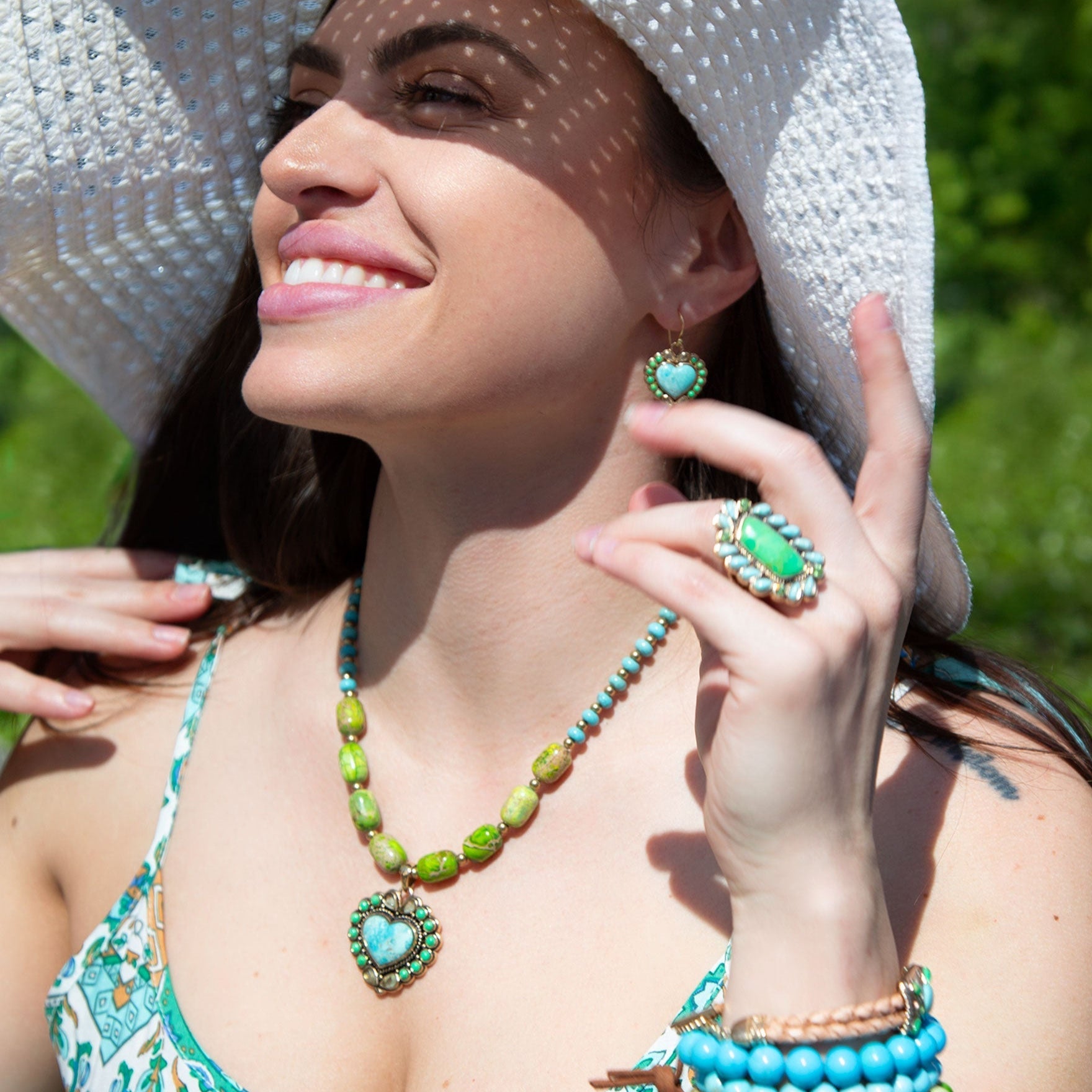 Woman wearing green and turquoise jewelry outdoors