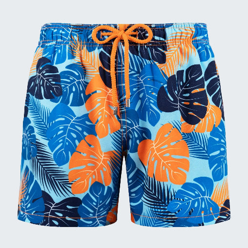 Tropical leaf patterned shorts with orange drawstring on a white background