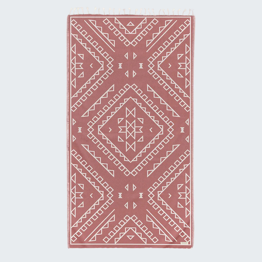 Pink rug with geometric pattern on a white background