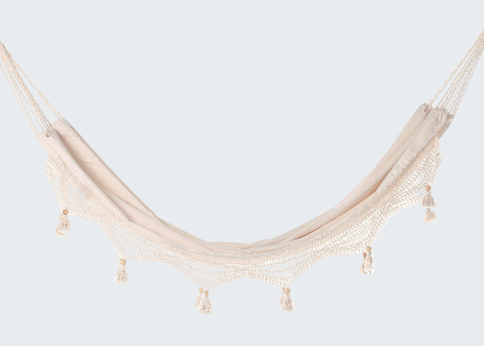 Beige hammock with tassels on a white background