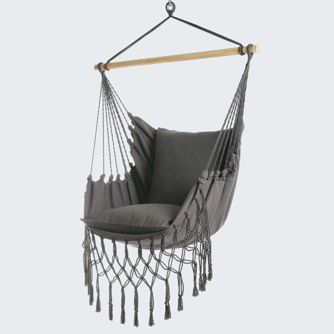 Gray hammock chair with tassels on a white background