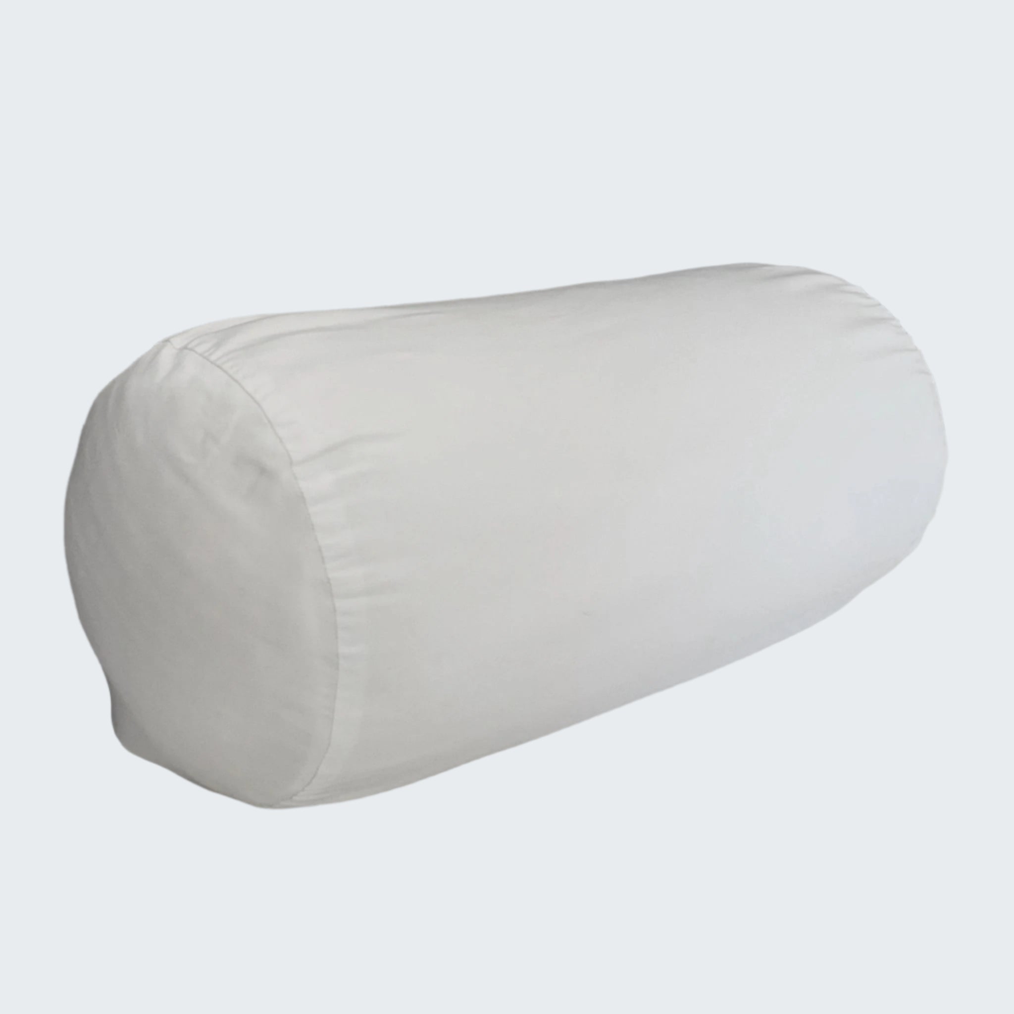 White cylindrical pillow on a gray sofa