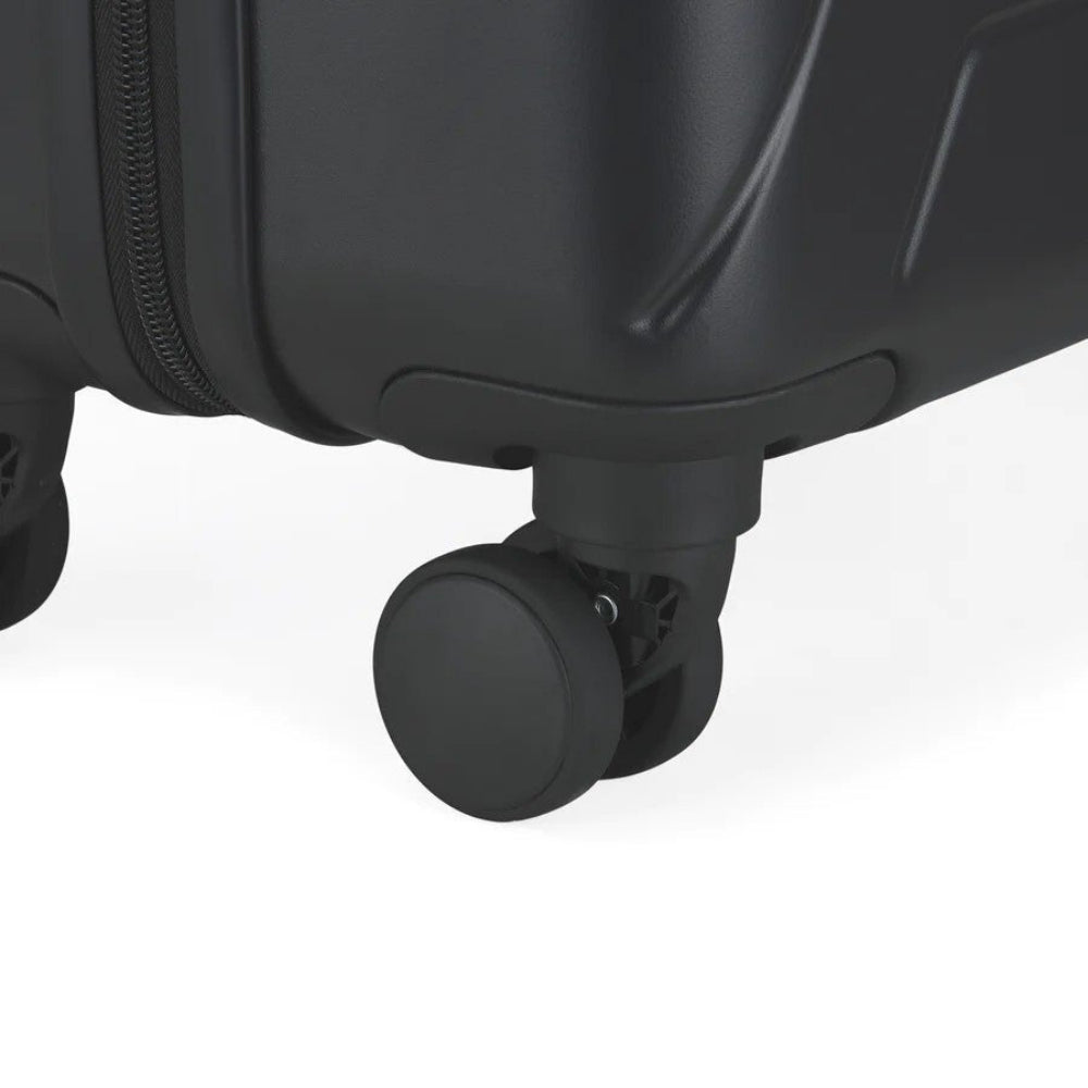 Close-up of a black suitcase wheel on a white background