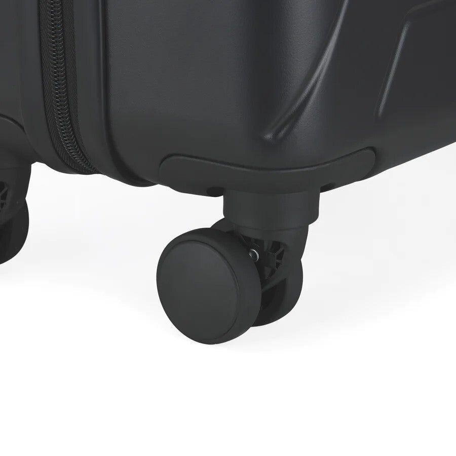 Close-up of a black suitcase wheel on a white background