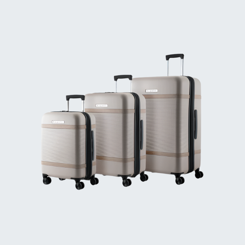 Set of three suitcases in beige with black accents on a white background