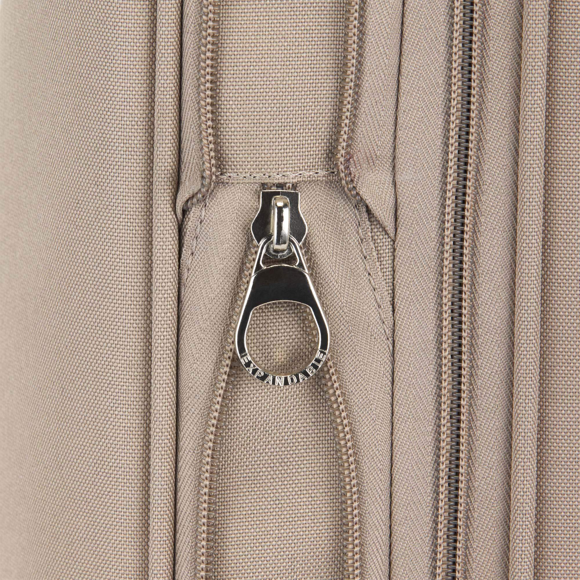 Close-up of a beige fabric with a zipper and metal pull tab.