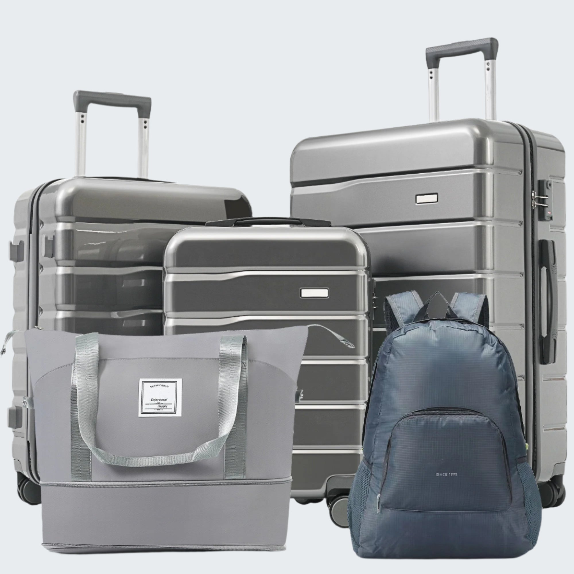 A set of grey luggage which includes three suitcases with 360° spinner wheels, a foldable backpack, and an expandable duffel bag.