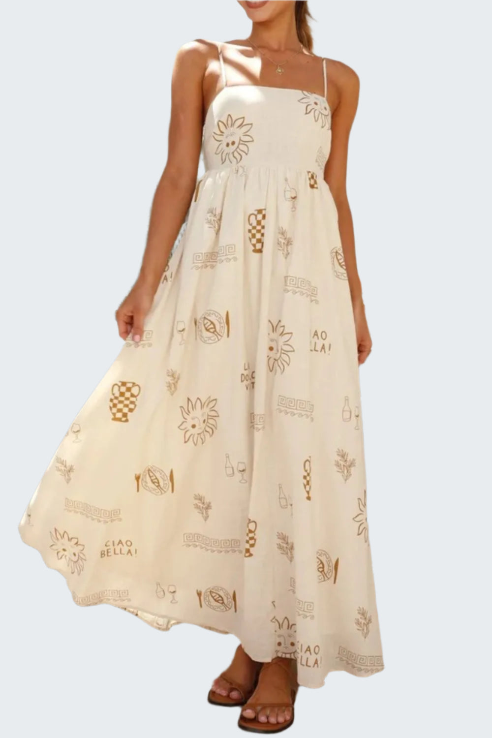 A woman wearing a beige maxi dress with a square neckline and floral patterns, standing on a tiled floor.
