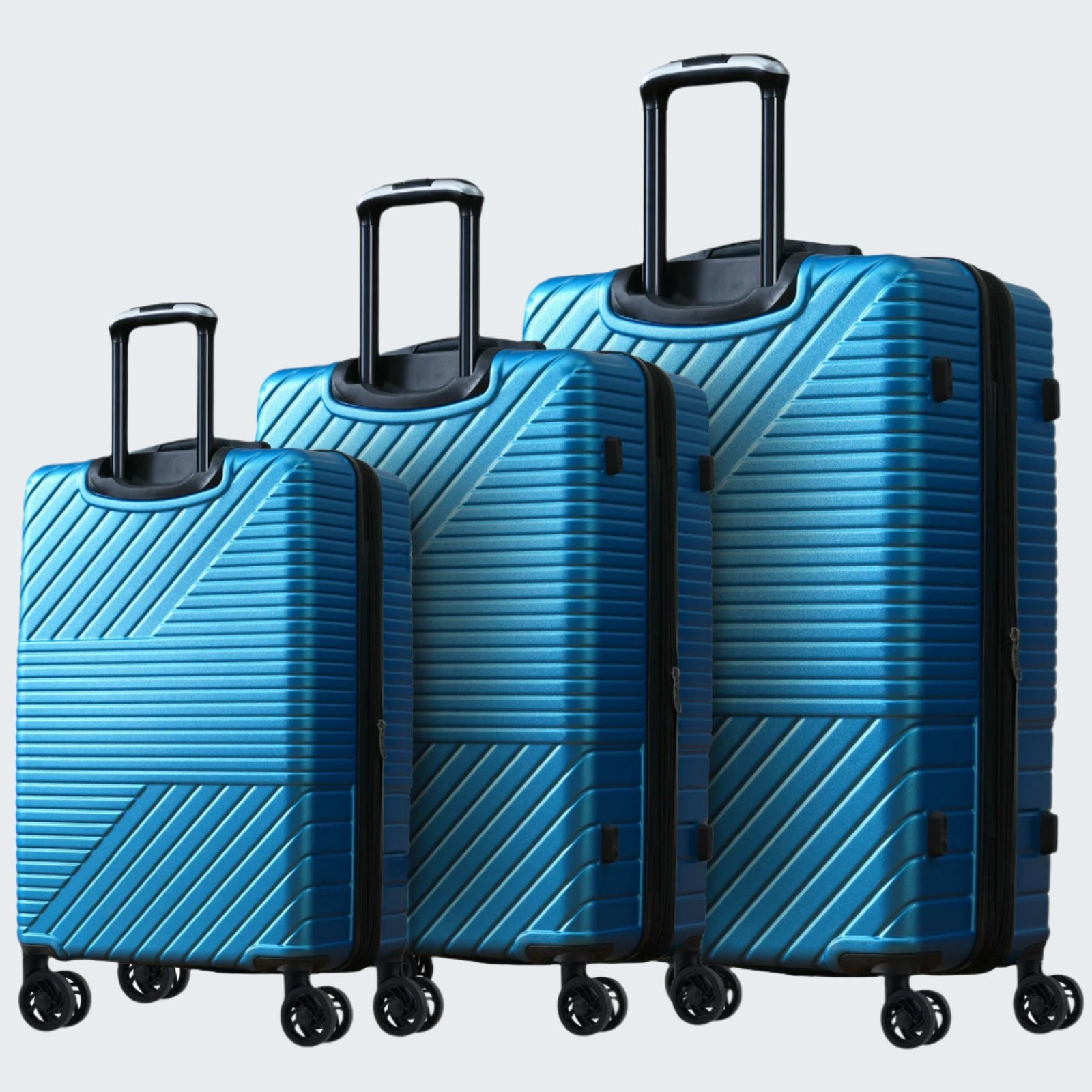 A set of three blue hardshell suitcases with a geometric pattern, featuring telescopic handles and four spinner wheels.