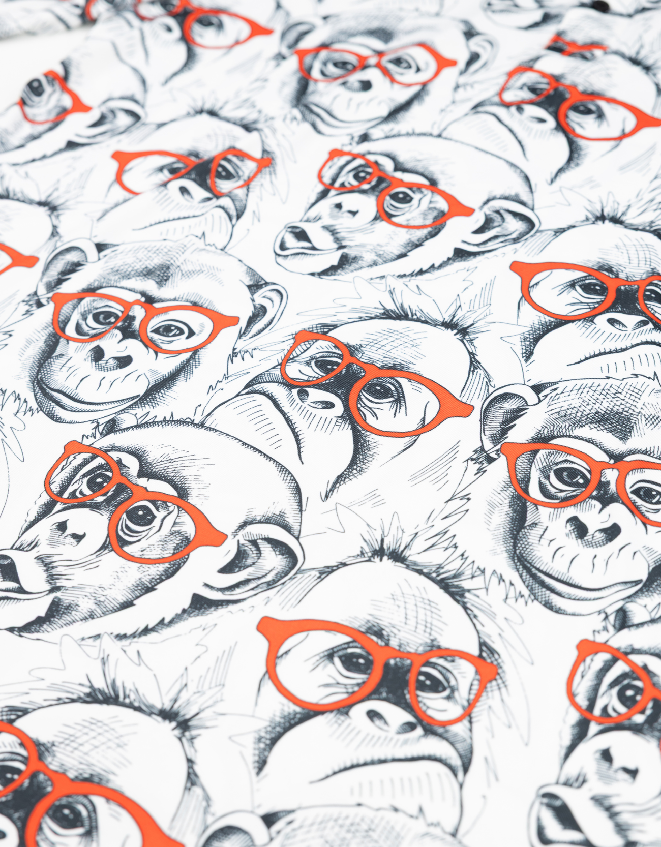 Pattern of monkeys wearing orange glasses on a white background