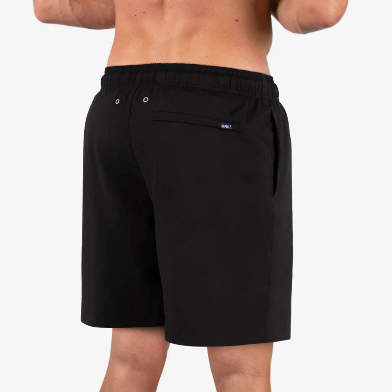 Black shorts worn by a person on a white background