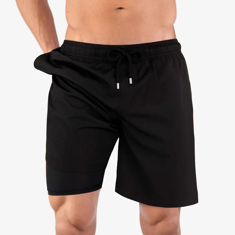 Black shorts worn by a person on a white background