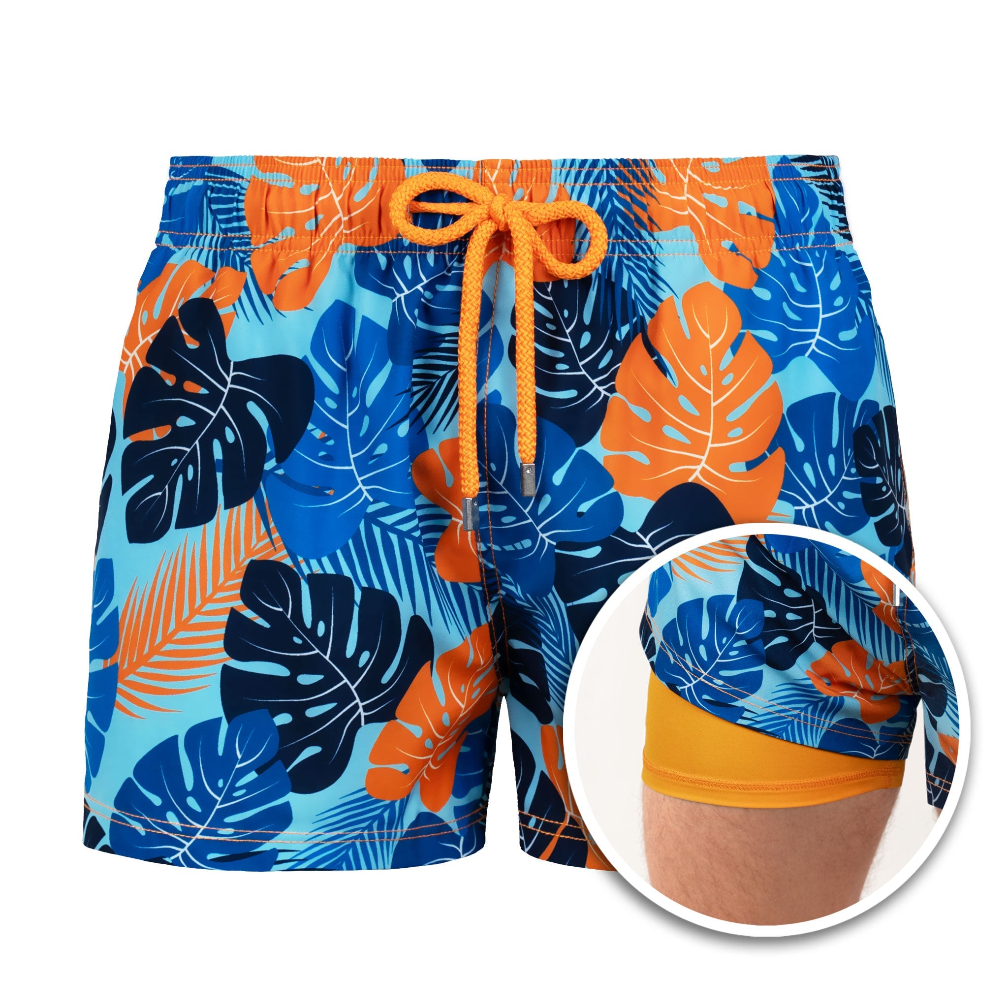 Colorful leaf-patterned swim shorts with orange drawstring on a white background