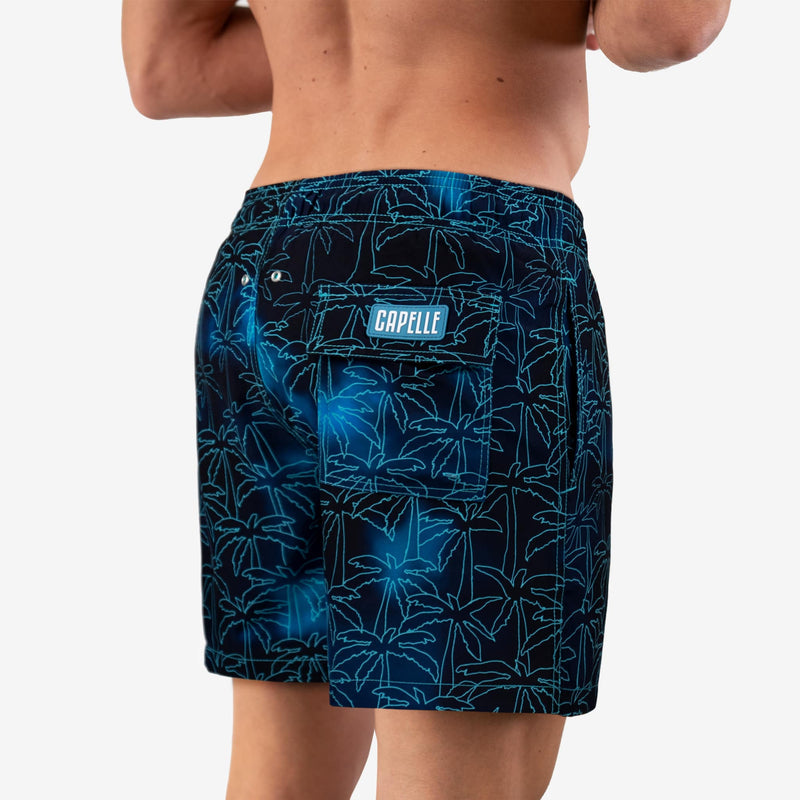 Person wearing blue patterned shorts with a visible brand logo on a white background