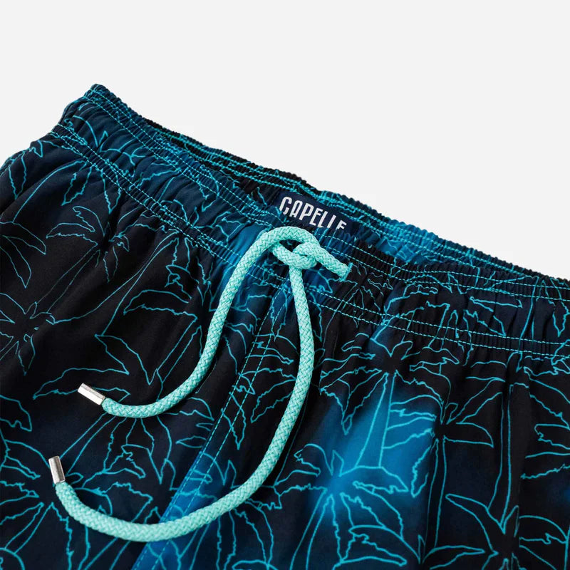 Navy swim shorts with blue floral pattern and brand logo on a light gray background