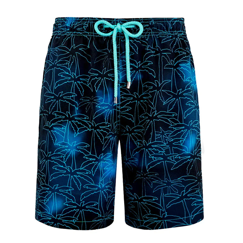 Blue swim shorts with palm tree pattern on a white background