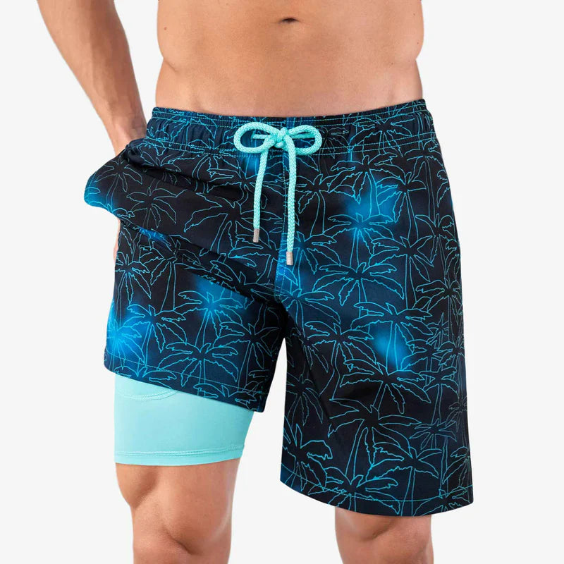 Blue and black patterned swim shorts with a drawstring on a white background