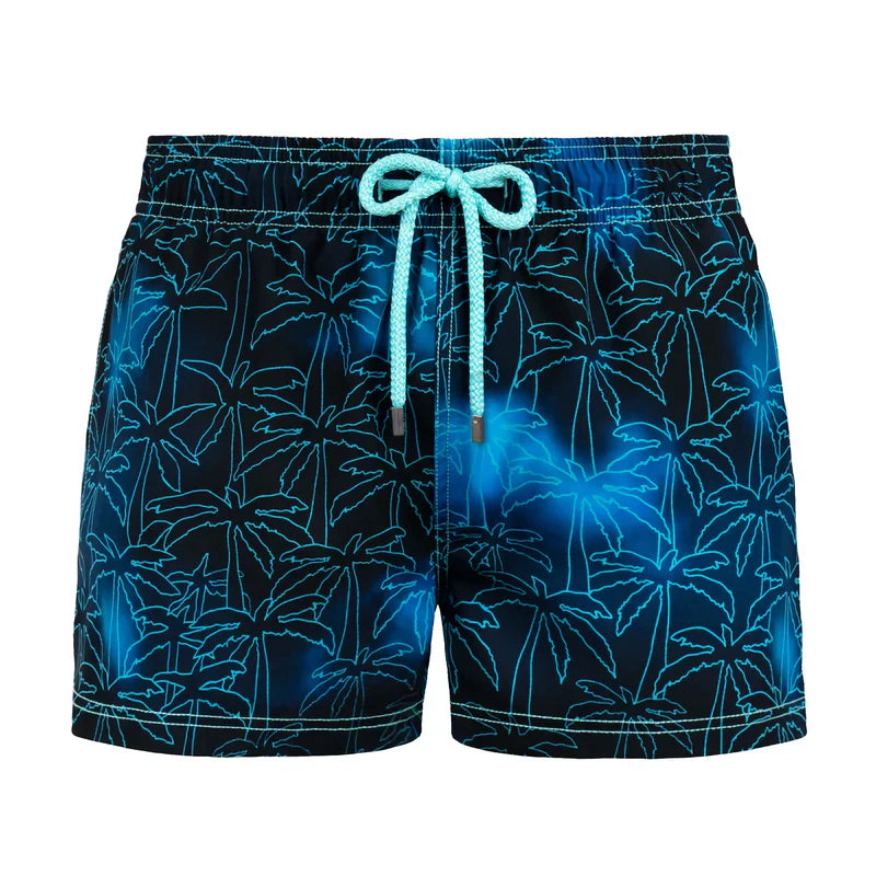Blue palm tree patterned shorts with a drawstring on a white background
