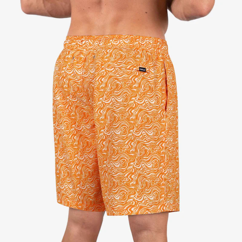 Orange patterned swim shorts on a white background