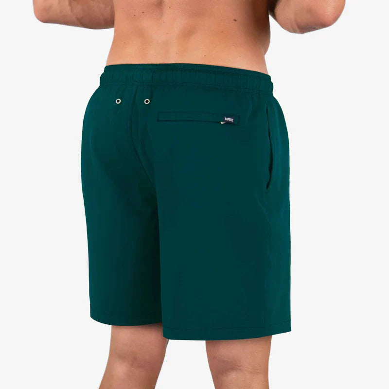 Green shorts worn by a person on a white background