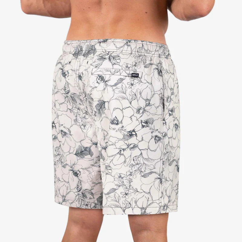 Floral patterned shorts worn by a person on a white background