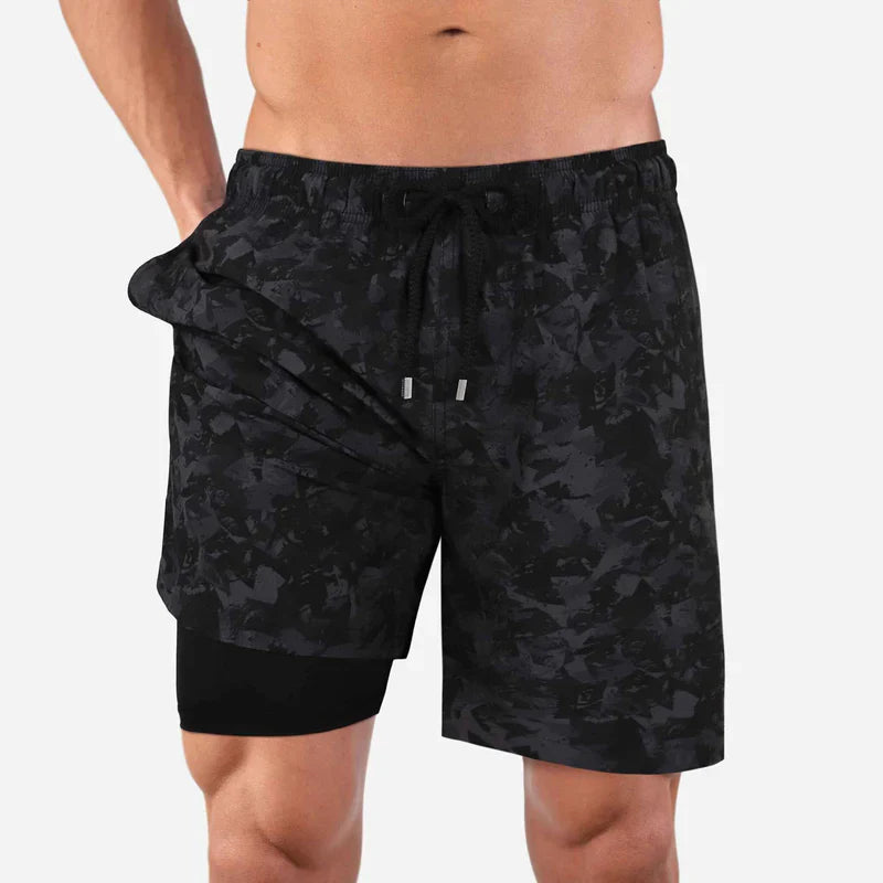Black camouflage shorts worn by a person on a white background