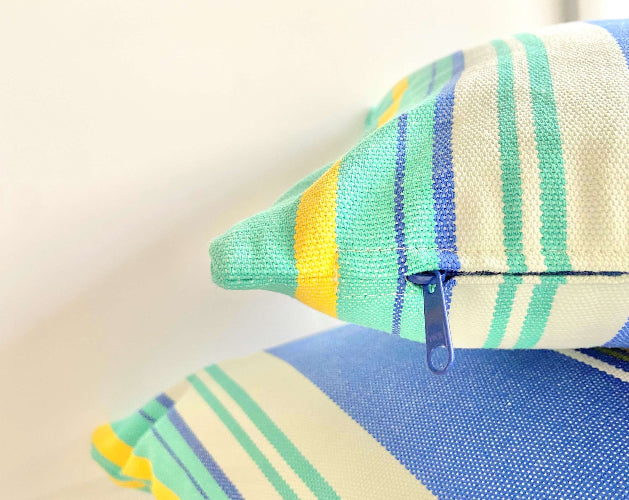 Colorful striped fabric with a zipper on a light background