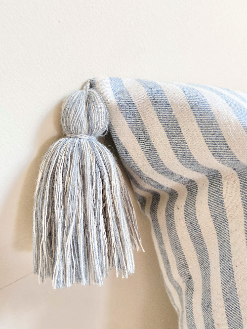 Striped blanket with tassel on a white background