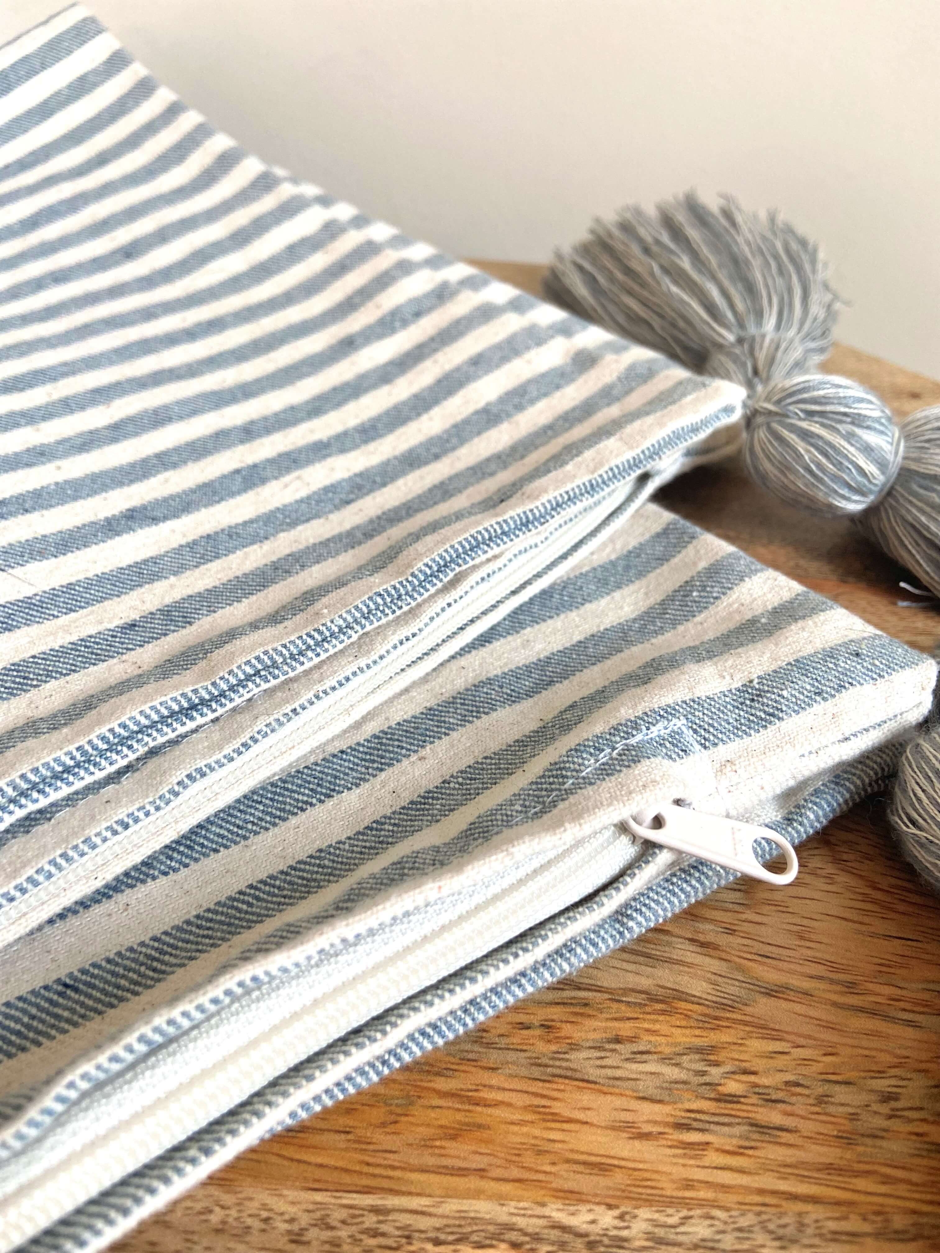 Striped fabric with a zipper on a wooden surface