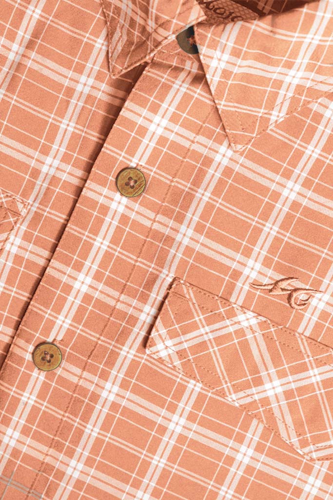 Close-up of a plaid shirt with a pink and white pattern